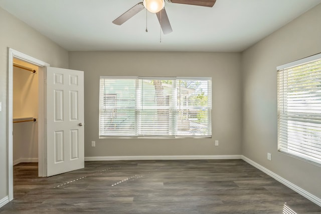 unfurnished room with dark hardwood / wood-style flooring, ceiling fan, and a wealth of natural light