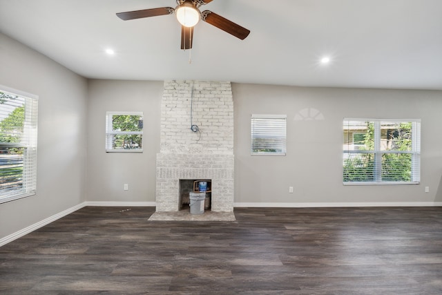 unfurnished living room featuring dark wood-type flooring, ceiling fan, and a fireplace