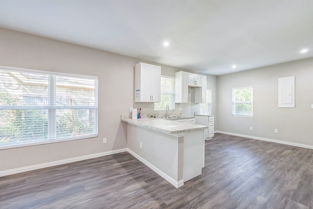 unfurnished living room featuring dark wood-type flooring, ceiling fan, and a fireplace