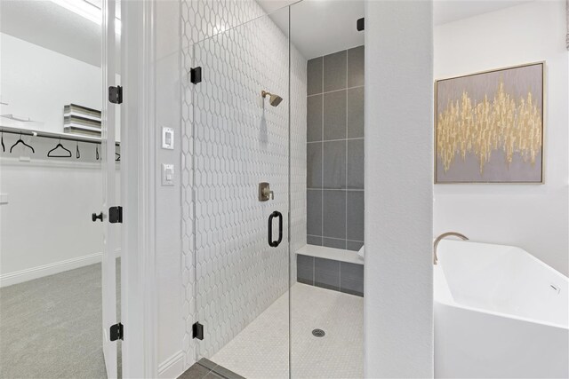 bathroom featuring separate shower and tub