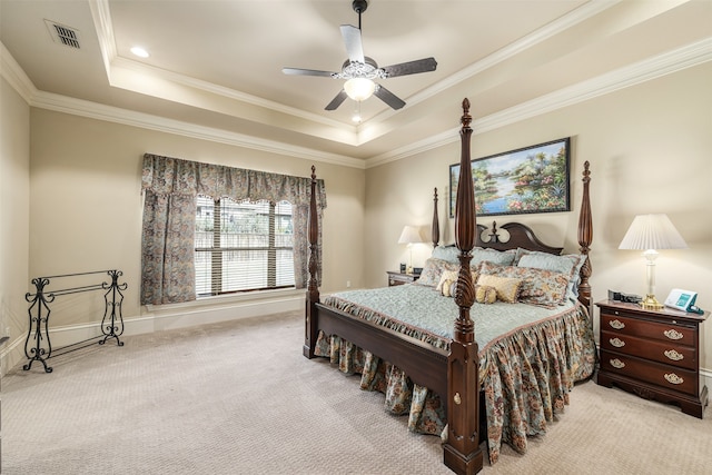 carpeted bedroom featuring ceiling fan, a tray ceiling, and crown molding