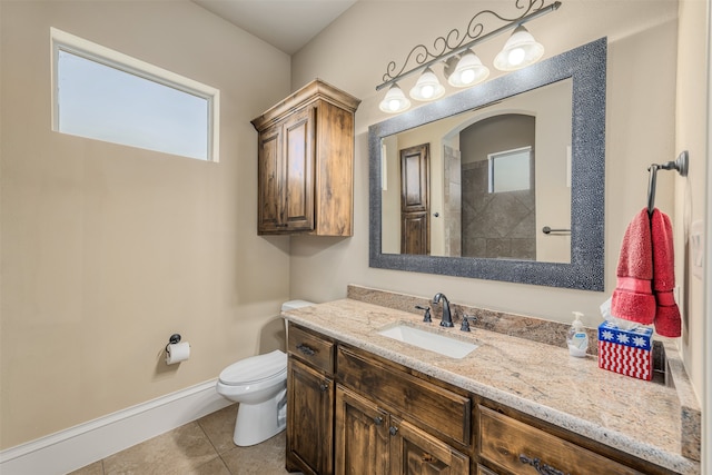 bathroom with tile patterned floors, vanity, walk in shower, and toilet