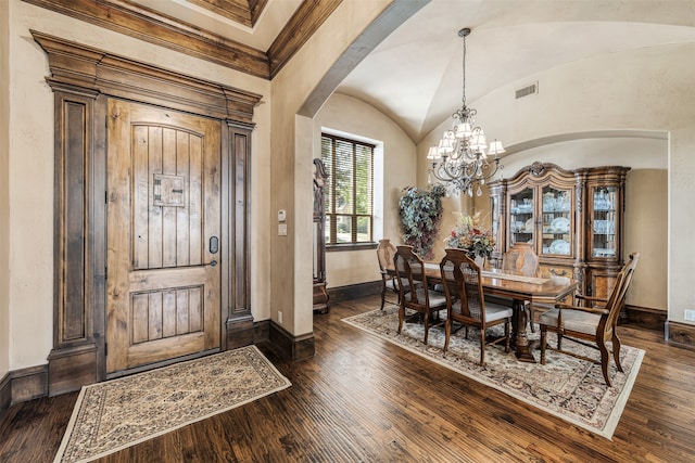 dining space featuring lofted ceiling, a chandelier, dark hardwood / wood-style flooring, and crown molding