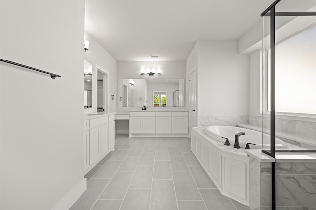 bathroom with tile patterned flooring, a washtub, and vanity