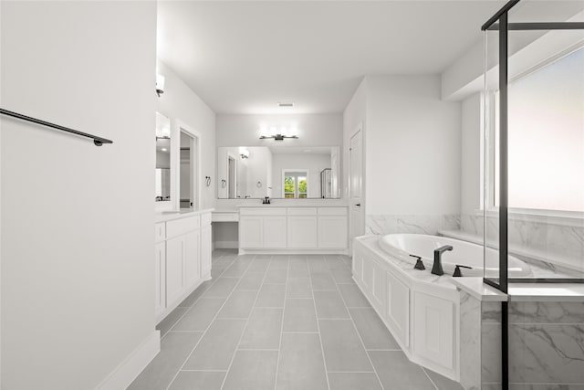 bathroom featuring vanity, a bath, and tile patterned floors