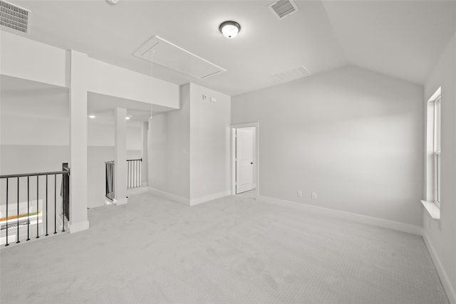 unfurnished room with vaulted ceiling and light carpet