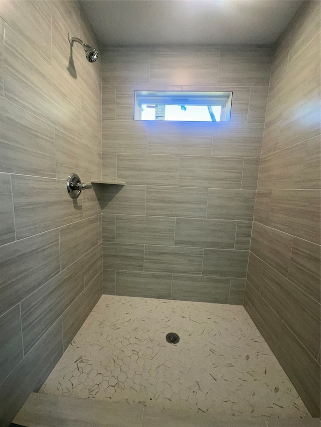 bathroom with a tile shower