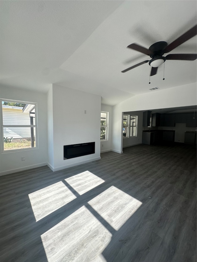 unfurnished living room featuring ceiling fan, lofted ceiling, and dark hardwood / wood-style flooring