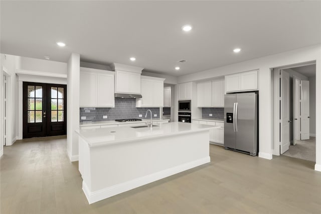 1008 Roys Dr, Rockwall, TX 75087 - kitchen featuring stainless steel appliances, a sink, light countertops, backsplash, and white cabinets