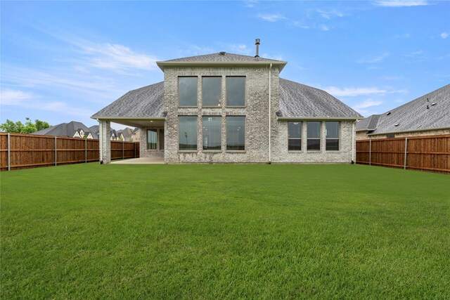 1008 Roys Dr, Rockwall, TX 75087 - rear view of house with brick siding, a shingled roof, and a patio
