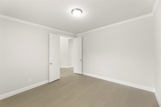 1008 Roys Dr, Rockwall, TX 75087 - empty room featuring wood finished floors, baseboards, and ornamental molding