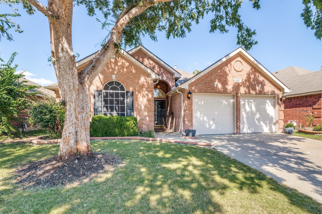 view of front facade with a front yard and a garage