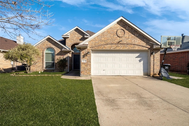 view of front facade with a garage, a front yard, and central AC