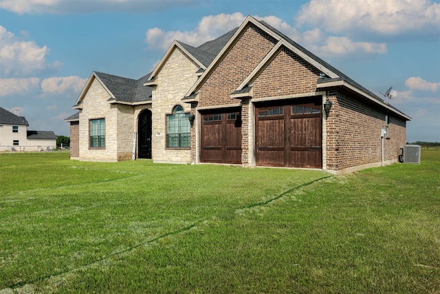 view of front of home with cooling unit and a front lawn