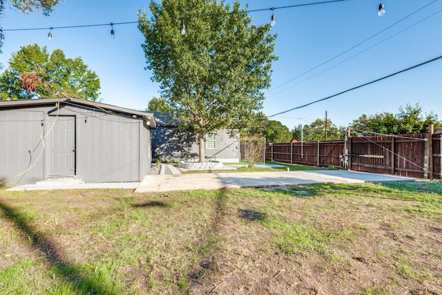 view of yard with a shed and a patio area