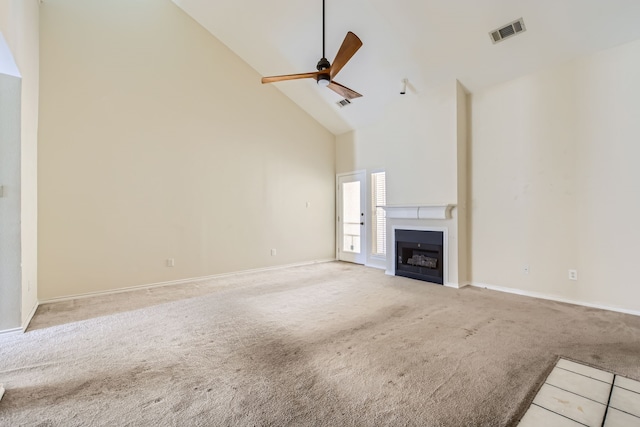 unfurnished living room with light carpet, ceiling fan, and high vaulted ceiling