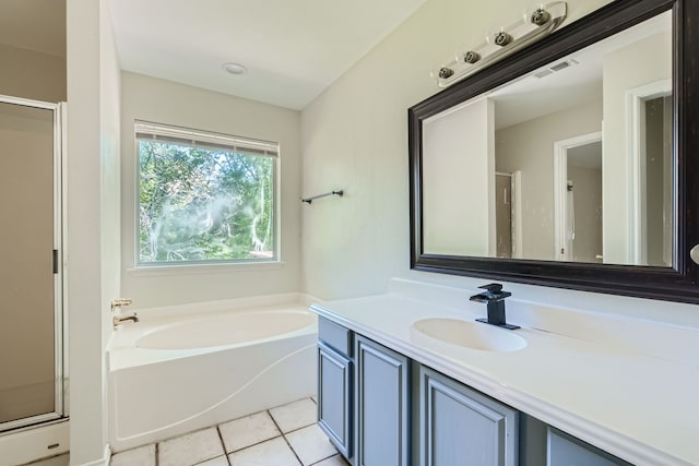 bathroom featuring tile patterned flooring, independent shower and bath, and vanity