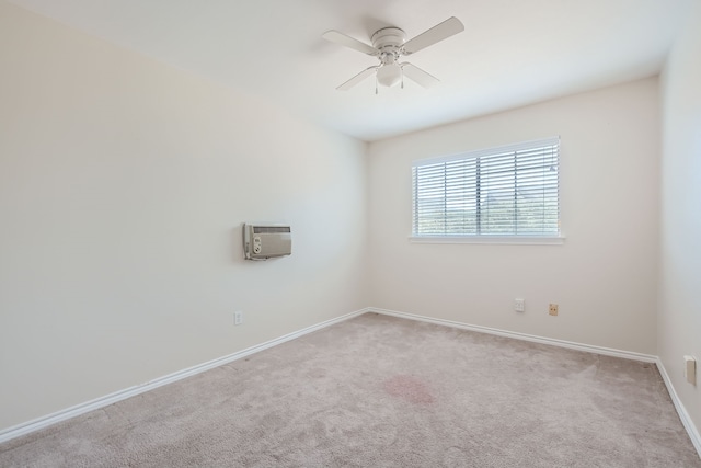 carpeted spare room with ceiling fan and a wall unit AC