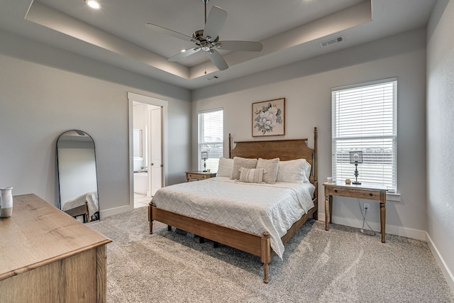 bedroom featuring a tray ceiling, ceiling fan, and light colored carpet