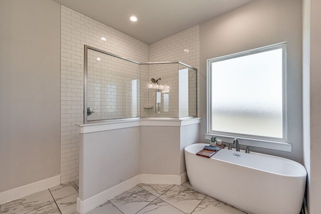 bathroom featuring separate shower and tub