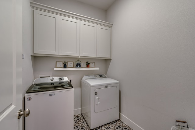 washroom featuring separate washer and dryer and cabinets