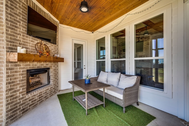 view of patio / terrace featuring an outdoor brick fireplace