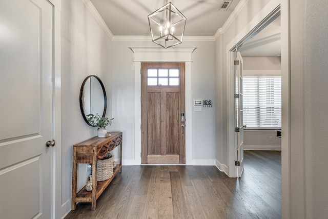 entryway with ornamental molding, a notable chandelier, and dark hardwood / wood-style flooring