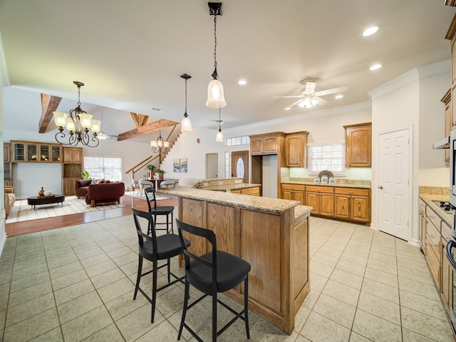 kitchen featuring a healthy amount of sunlight, light tile patterned floors, and ceiling fan with notable chandelier