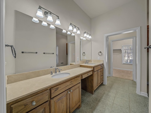 full bath featuring vanity, baseboards, and tile patterned floors
