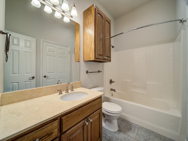 bathroom featuring tile patterned floors, vanity, toilet, and bathing tub / shower combination