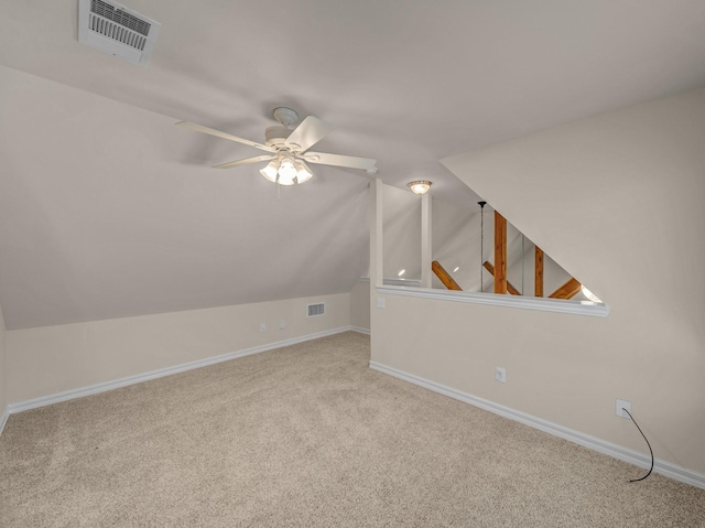 bonus room featuring ceiling fan, visible vents, baseboards, vaulted ceiling, and carpet