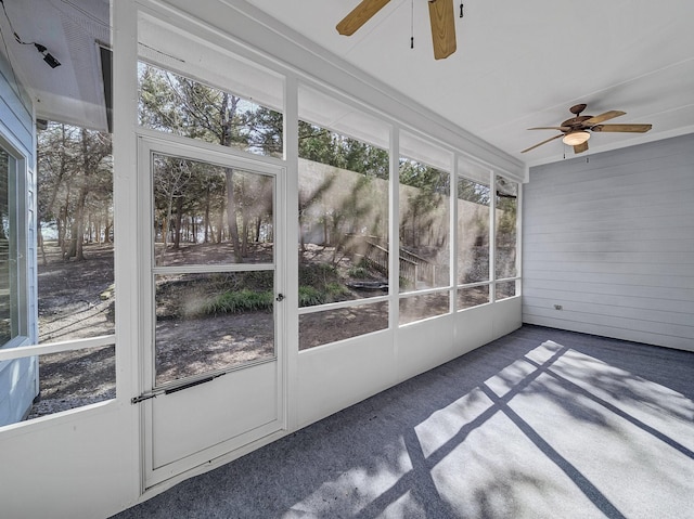 unfurnished sunroom featuring a ceiling fan