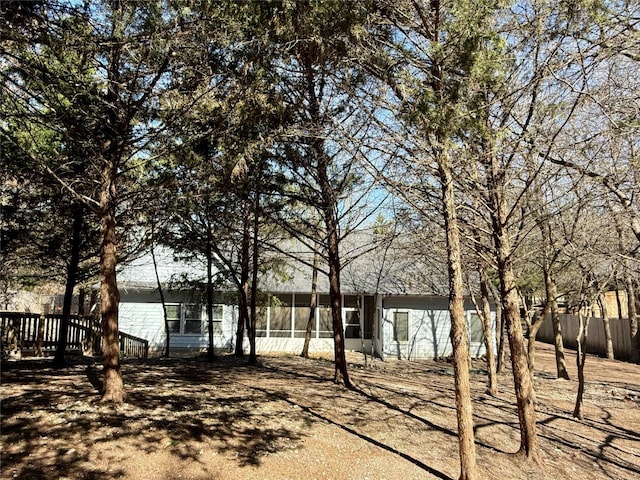 view of yard with a sunroom and fence
