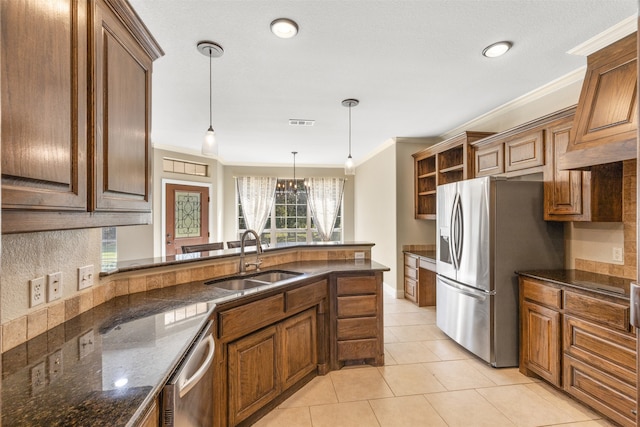 kitchen with hanging light fixtures, an inviting chandelier, ornamental molding, stainless steel appliances, and sink