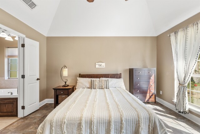 bedroom with ensuite bathroom, vaulted ceiling, and ceiling fan