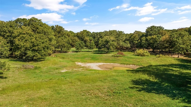 surrounding community featuring a yard and a rural view