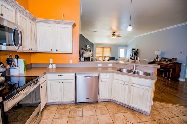 kitchen featuring sink, white cabinetry, light tile patterned floors, kitchen peninsula, and stainless steel appliances