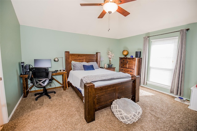 carpeted bedroom with lofted ceiling, ceiling fan, and baseboards