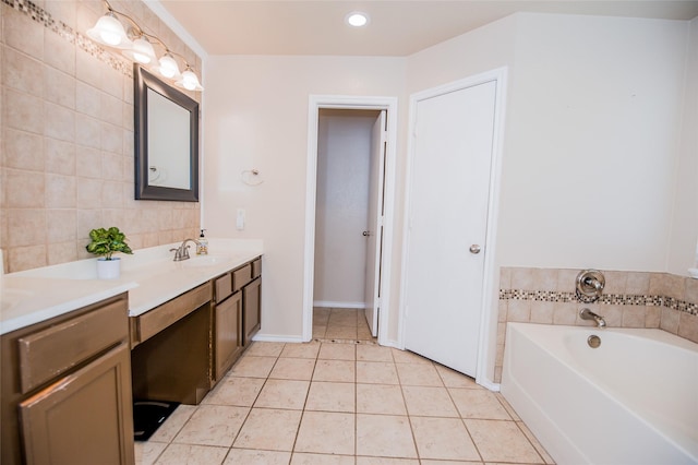 bathroom featuring baseboards, tile patterned floors, vanity, a bath, and recessed lighting