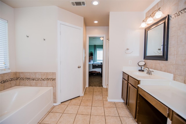 bathroom featuring visible vents, connected bathroom, vanity, tile patterned flooring, and a bath