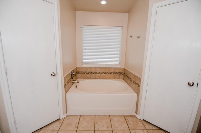 bathroom featuring a garden tub and tile patterned floors