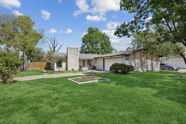 view of front facade with a garage and a front lawn