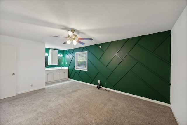 unfurnished room with ceiling fan and light carpet