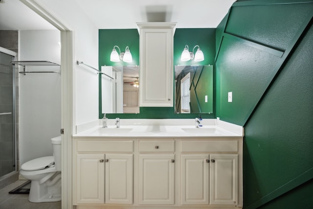 bathroom with tile patterned flooring, walk in shower, vanity, and toilet