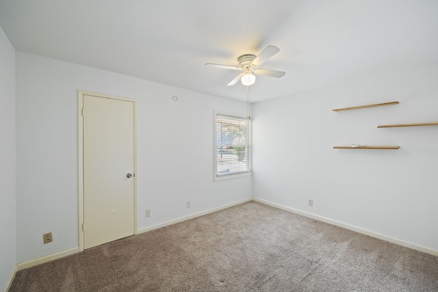 unfurnished room featuring ceiling fan and carpet