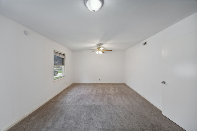 carpeted spare room featuring ceiling fan