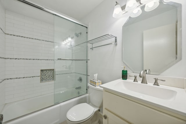 full bathroom with vanity, toilet, and combined bath / shower with glass door