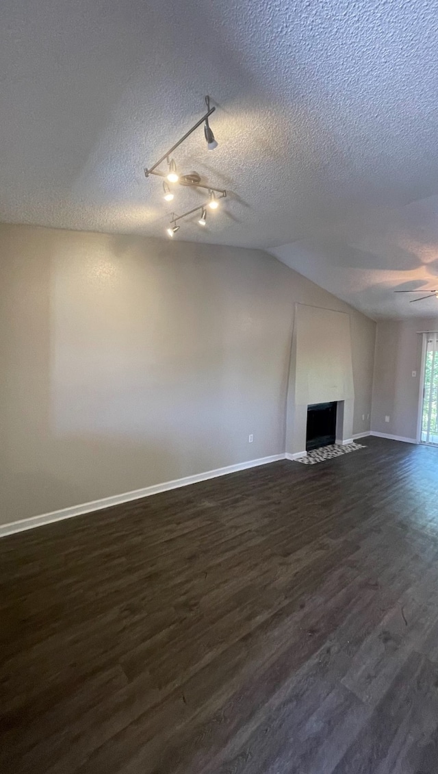 unfurnished living room featuring a textured ceiling and dark wood-type flooring