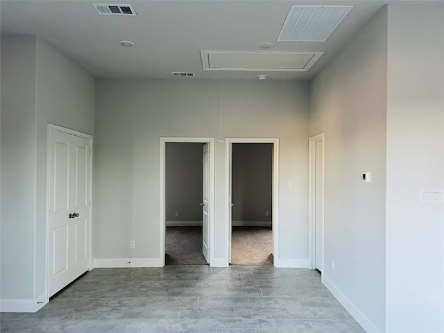 carpeted spare room with a high ceiling