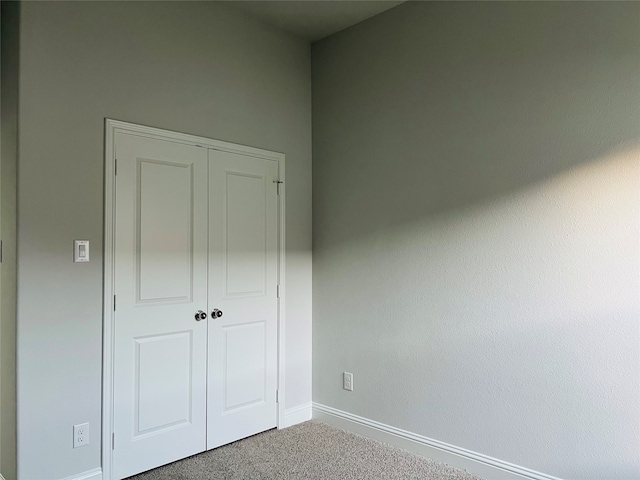 unfurnished bedroom featuring a closet and carpet flooring